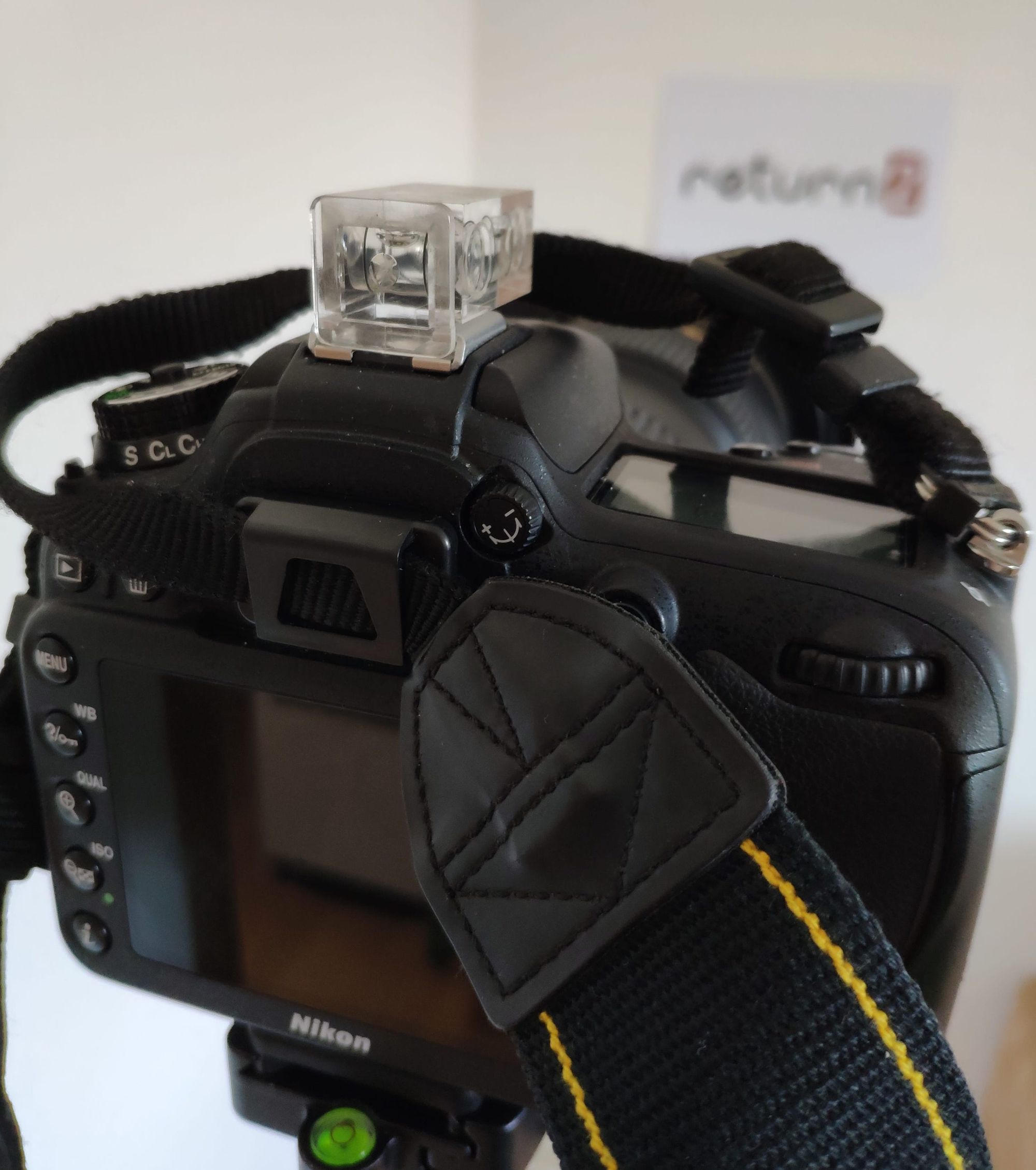 A Nikon DSLR camera with an eyepiece caps on the viewport